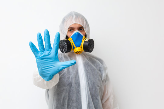 Man in protective clothing and a gasmask on a white background