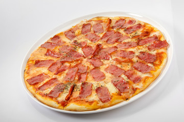 Flatlay of Italian pizza on wooden background. Rustic homemade pizzas with salami, bacon,  cheese, eggs and raw vegetables on shabby wooden background. Healthy vegetarian fungi pizza