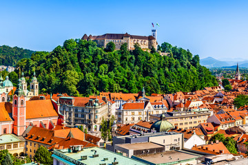 Old town and the medieval Ljubljana castle on top of a forest hill in Ljubljana, Slovenia - obrazy, fototapety, plakaty