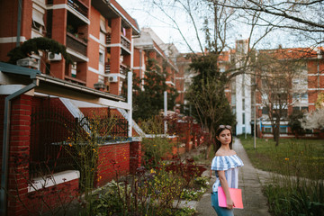  A beautiful young caucasian girl with a notebook in the park