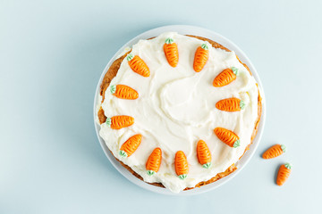 Easter carrot cake with frosting on blue background