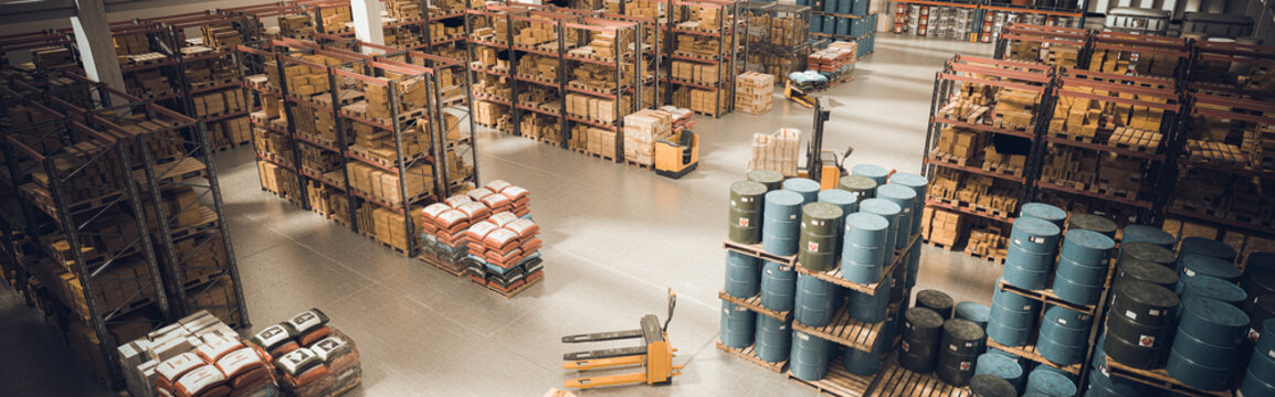 interior of a large warehouse with stored material and means for moving the pallets.