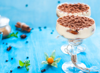 luxury tiramisu dessert in a cocktail glass decorated with cocoa