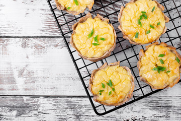 Mini pies with rye dough and mashed potato filling on the metallic lattice. Karelian Kalitki, Russian cuisine meal © kcuxen