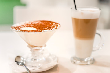 Tiramisu in a glass sprinkled with cocoa, trace from a spoon
