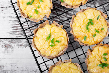 Mini pies with rye dough and mashed potato filling on the metallic lattice. Karelian Kalitki,...