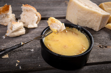 Swiss fondue melted cheese served with bread