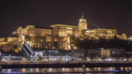 Fototapeta na wymiar Buda Castle by the Danube river illuminated at night in Budapest, Hungary