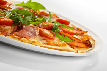 Flatlay of Italian pizza on wooden background. Rustic homemade pizzas with salami, bacon,  cheese, eggs and raw vegetables on shabby wooden background. Healthy vegetarian fungi pizza