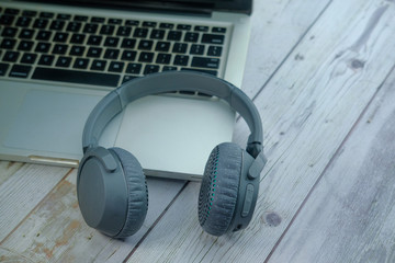 Obraz na płótnie Canvas Headset or headphone on laptop, top view