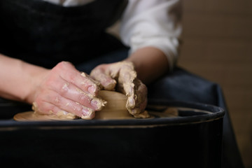 The master works behind the potter's wheel