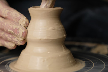 The master works behind the potter's wheel
