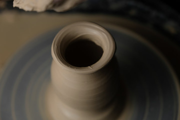 The master works behind the potter's wheel