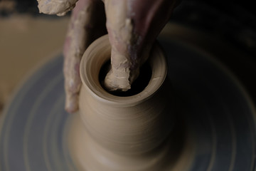 The master works behind the potter's wheel