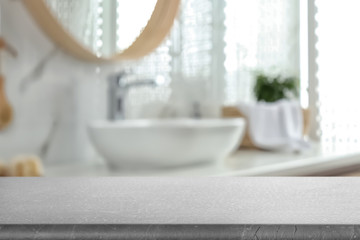 Empty table and blurred view of stylish bathroom interior
