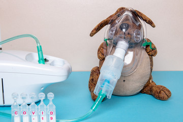 Coronavirus. Funny dog with a medical face mask or nebulizer for treatment of the respiratory tract...