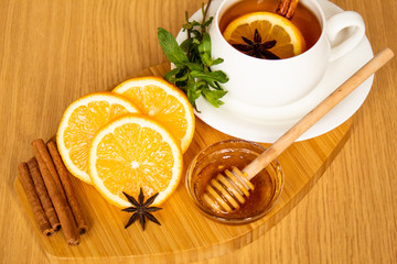 cup of tea with lemon and mint on a wooden background. selective focus. immunity. flu. treatment....