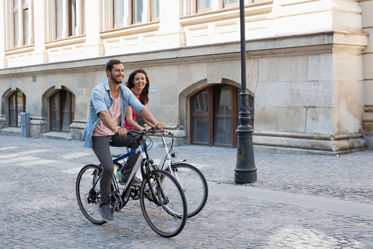 Young couple riding bicycle.