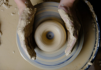 Fototapeta premium The master works behind the potter's wheel