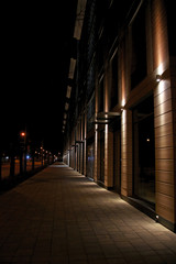 Fototapeta na wymiar office building facade lit by spotlights in the dark of night
