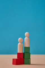Wooden cube and figures. Colorful cubes mockup, copy space. Career ladder. Business growth, development. Place for text