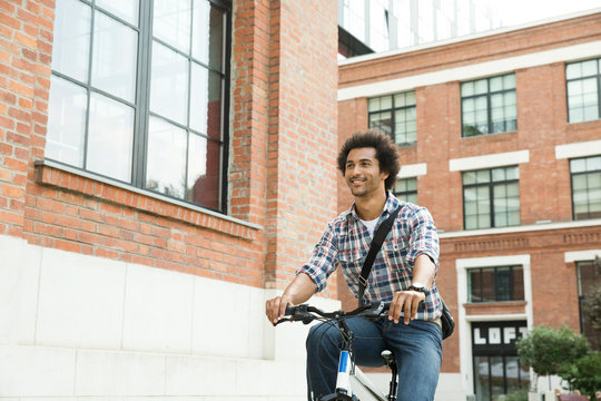 Young man riding bicycle.