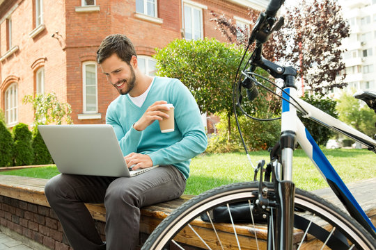 Businessman using laptop at business centre.