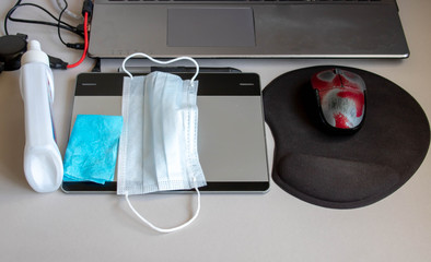 Concept work from home.Protective masks on the laptop, notebook,napkins,glass of water on the table