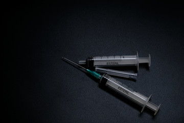 A small syringe into which a hollow, sharp-pointed bevel-cut needle is inserted and is used to inject medicinal substances into tissues or organs.