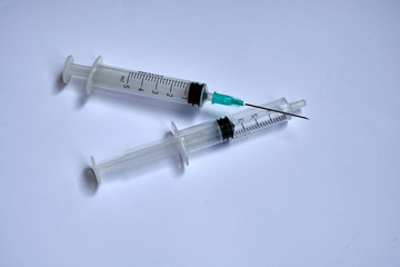 A small syringe into which a hollow, sharp-pointed bevel-cut needle is inserted and is used to inject medicinal substances into tissues or organs.