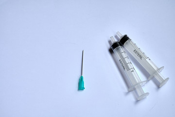 A small syringe into which a hollow, sharp-pointed bevel-cut needle is inserted and is used to inject medicinal substances into tissues or organs.