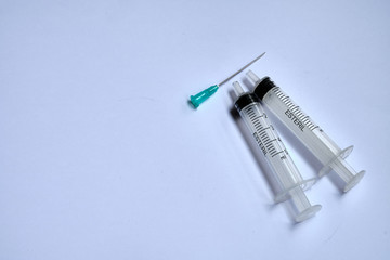 A small syringe into which a hollow, sharp-pointed bevel-cut needle is inserted and is used to inject medicinal substances into tissues or organs.