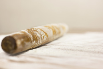 Kitchen rolling pin on flour. Background. To cook