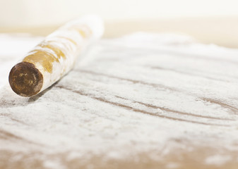 Kitchen rolling pin on flour. Background. To cook