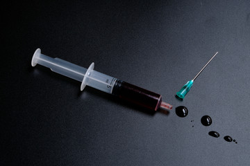 A small syringe into which a hollow, sharp-pointed bevel-cut needle is inserted and is used to inject medicinal substances into tissues or organs.