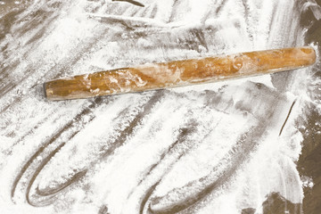 Kitchen rolling pin on flour. Background. To cook