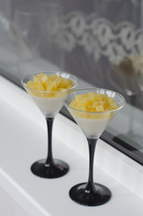 Panna cotta with pear and orange in a glass