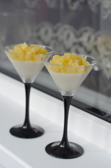 Panna cotta with pear and orange in a glass