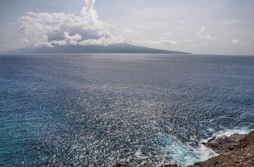 Puffy white clouds over the island of Brave as seen from Djeu in Cabo Verde