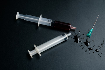 A small syringe into which a hollow, sharp-pointed bevel-cut needle is inserted and is used to inject medicinal substances into tissues or organs.