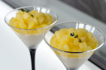 Panna cotta with pear and orange in a glass