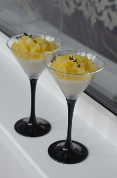 Panna cotta with pear and orange in a glass