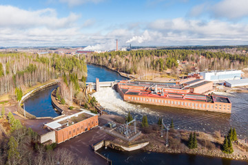 Fototapeta premium Aerial view of hydroelectric power generation plant and Ankkapurha Industrial Museum at Kymijoki river, Finland.