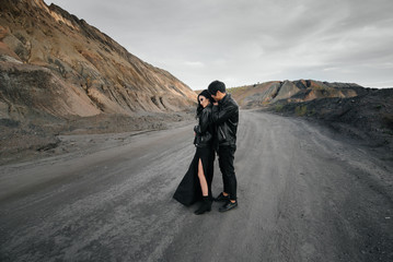 Asian couple in love in black leather clothes walking in nature. Style, fashion, love