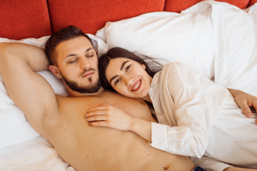 Love couple in pajamas sleeping in bed at home