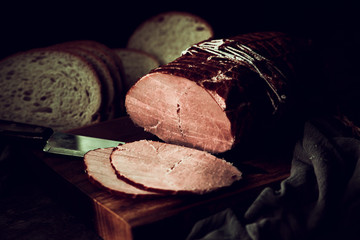smoked gammon on a wooden table with Bread.