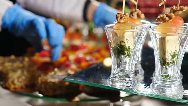 Restaurant snacks serving. Beautifully decorated catering banquet table with canape in hotel. catering service buffet food set in event celebration, corporate or birthday party or wedding. 4 k video