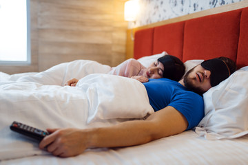 Fototapeta premium Love couple sleeping in eye covers, healthy sleep