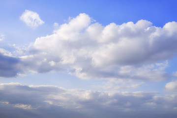 Background clouds on blue sky, copy space. White Cumulus clouds in clear weather. The sky on a sunny summer day.