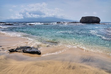 Fototapeta na wymiar Waves wash ashore on the warm volcanic islet of Djeu in Cabo Verde